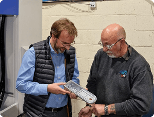 Mr. Rawnson discussing one of the first jobs to be put on the Brother SPEEDIO R650X2 machining center
